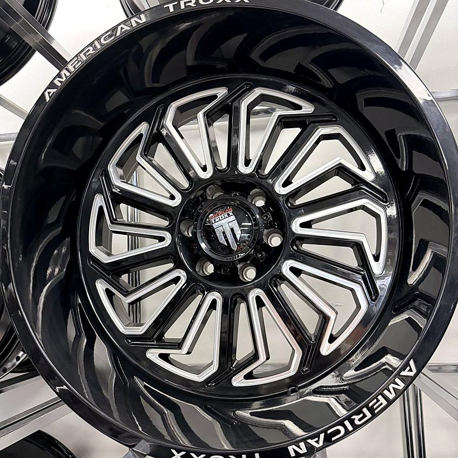 American Truxx gloss black truck wheel with milled spokes and deep lip on the wheel wall at Llantera Del Norte INC, 606 Peoria St, Aurora, Colorado / Rin de troca American Truxx negro brillante con rayos fresados y labio profundo en Llantera Del Norte INC en Aurora, Colorado