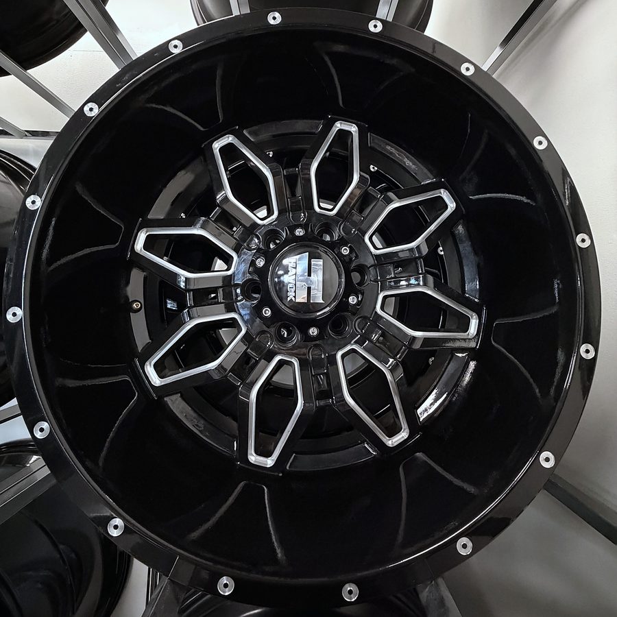 Havok gloss black milled truck wheel with deep lip and eight-lug pattern, in stock at Llantera Del Norte INC, 606 Peoria St, Aurora, Colorado / Rin de camioneta Havok negro brillante con detalle rebajado, labio profundo y ocho birlos, disponible en Llantera Del Norte INC en Aurora, Colorado